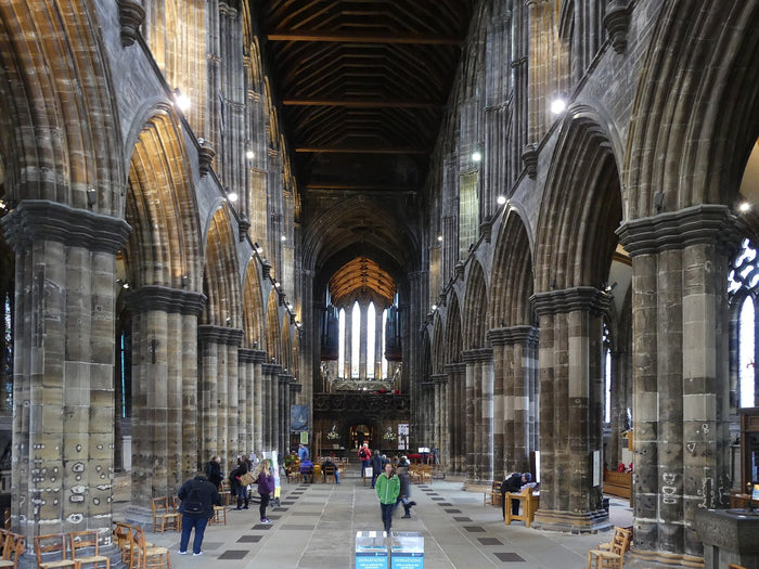 The nave of Glasgow Cathedral, with tall stone arches and a timber roof