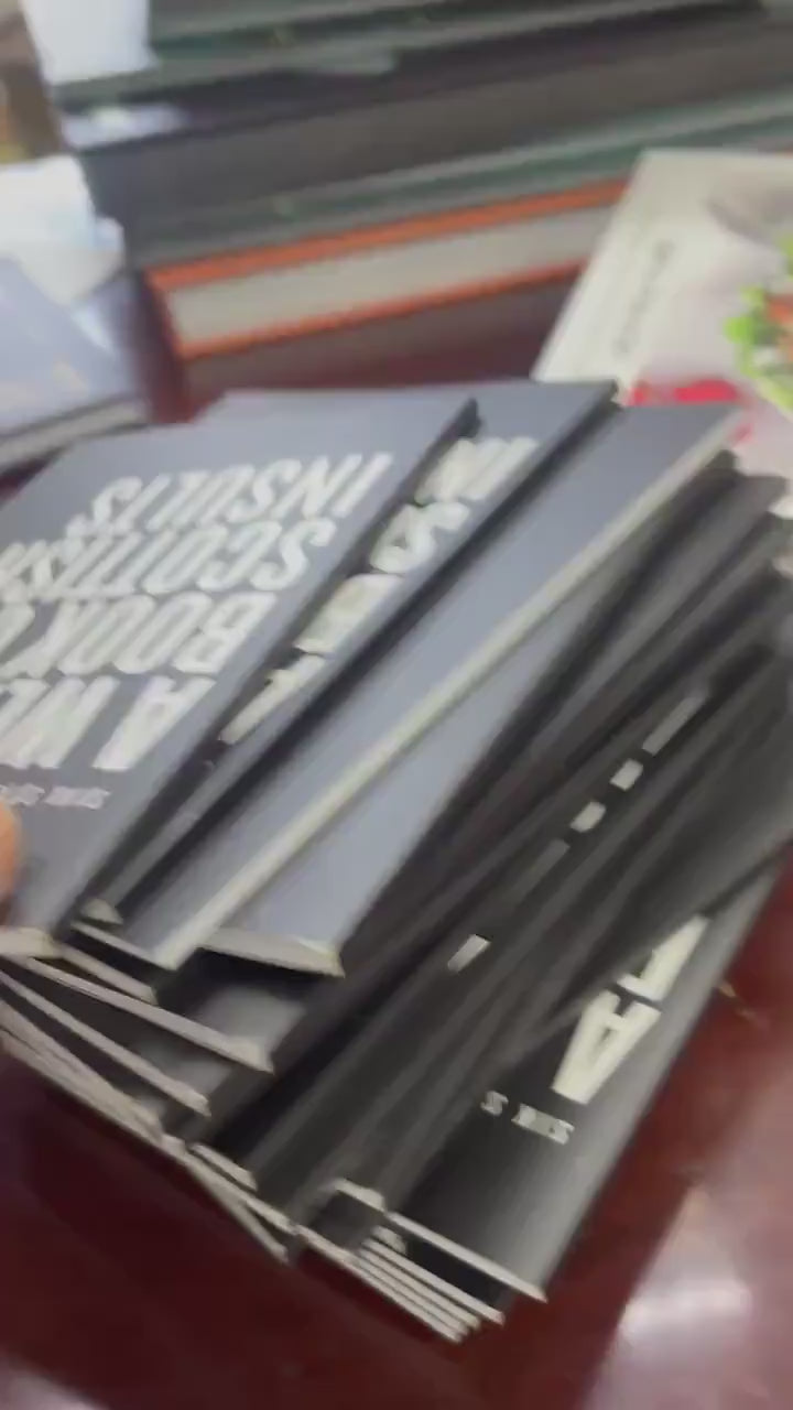 A Wee Book of Scottish Insults — video of a stack of copies of the black paperback on a table